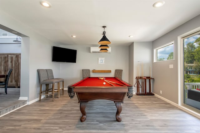 playroom featuring recessed lighting, a wall mounted air conditioner, baseboards, and wood finished floors