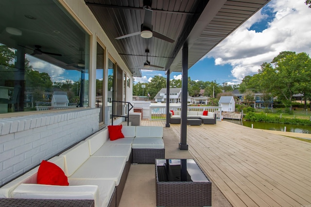 exterior space featuring an outdoor hangout area, ceiling fan, and a water view