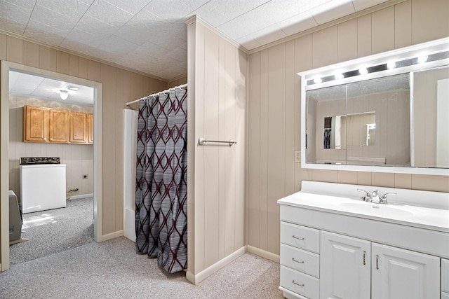 full bathroom with washer / dryer, baseboards, a shower with curtain, ornamental molding, and vanity