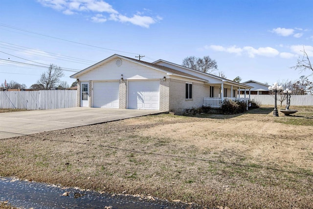 single story home with brick siding, a porch, fence, a garage, and driveway