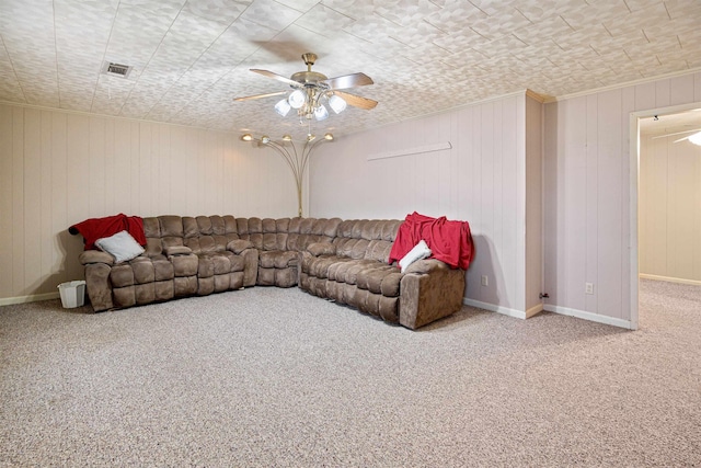 carpeted living area with ceiling fan, crown molding, visible vents, and baseboards