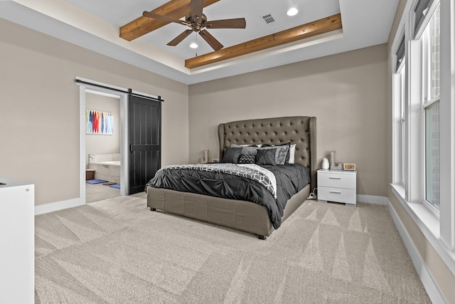 bedroom featuring light carpet, a barn door, visible vents, and baseboards