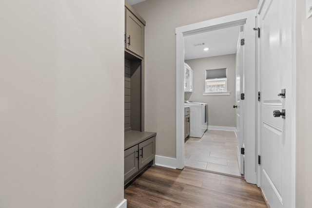 interior space with visible vents, dark wood-type flooring, cabinet space, and baseboards