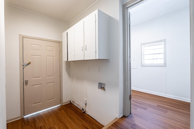 laundry area with washer hookup, cabinet space, crown molding, and light wood-style flooring