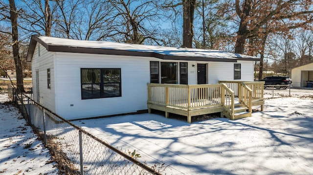 exterior space featuring fence and a wooden deck