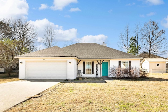 ranch-style house with roof with shingles, a chimney, an attached garage, a front yard, and driveway