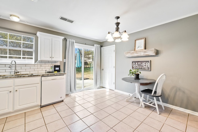 kitchen featuring visible vents, decorative backsplash, white dishwasher, white cabinetry, and a sink