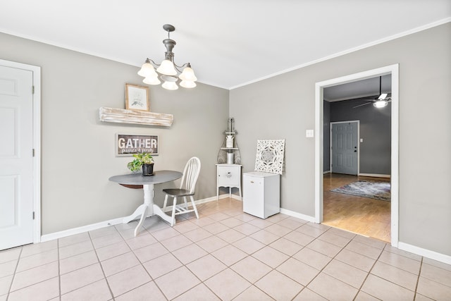 unfurnished dining area with light tile patterned floors, baseboards, ornamental molding, and a chandelier