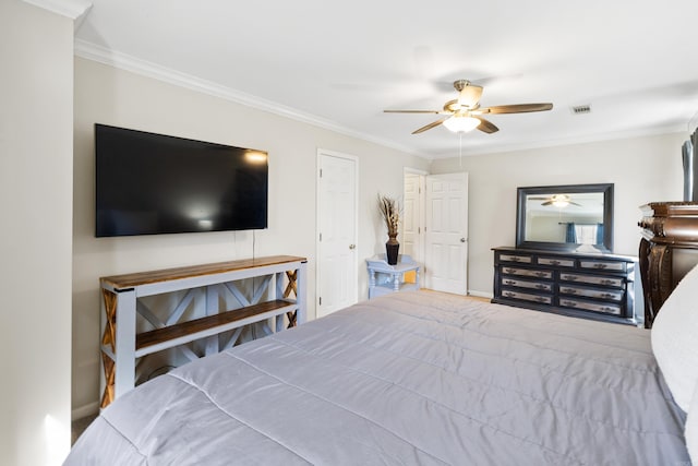 bedroom featuring baseboards, visible vents, ornamental molding, and a ceiling fan