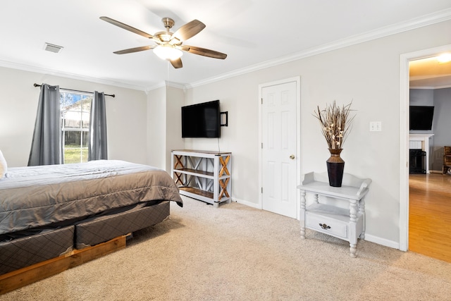 bedroom with light carpet, ornamental molding, a fireplace, and baseboards