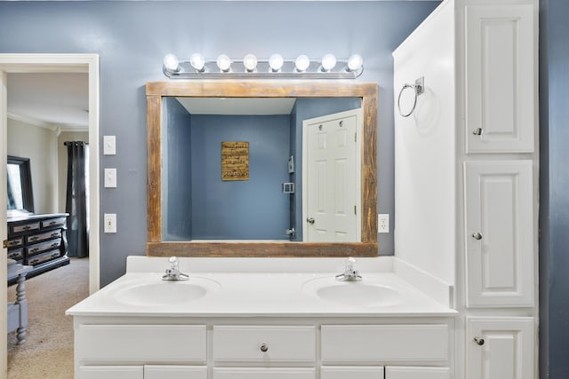 full bathroom with ornamental molding, a sink, and double vanity