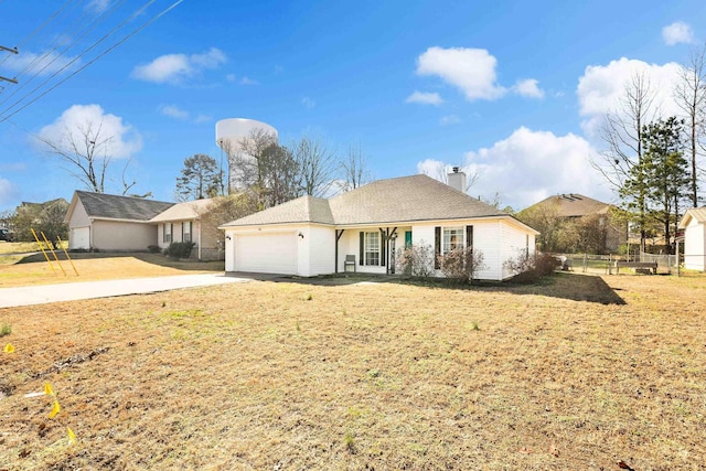 ranch-style home featuring a garage, driveway, a chimney, fence, and a front yard