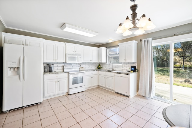 kitchen featuring white appliances, light stone counters, crown molding, white cabinetry, and a sink