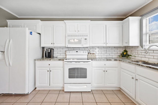 kitchen featuring white appliances, white cabinetry, a sink, and light tile patterned flooring