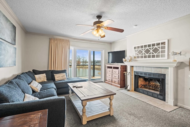 living area featuring a textured ceiling, ornamental molding, and a tiled fireplace