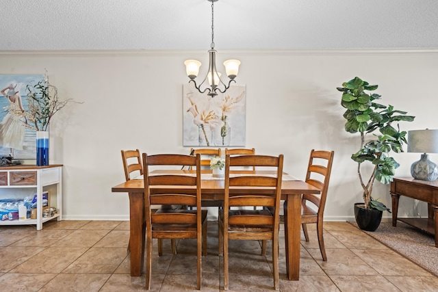 dining space featuring crown molding, light tile patterned floors, a textured ceiling, a chandelier, and baseboards