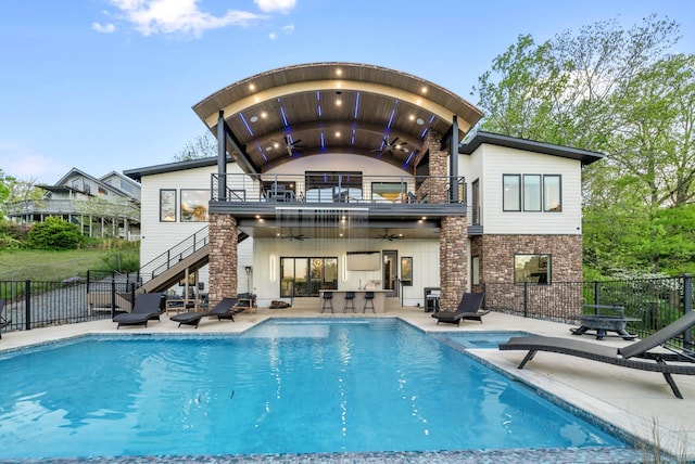 rear view of house with a fenced in pool, a patio, ceiling fan, stairway, and fence