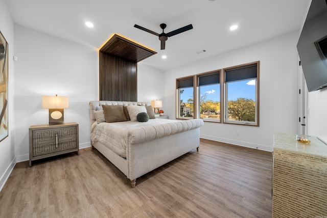 bedroom with light wood-style floors, ceiling fan, baseboards, and recessed lighting