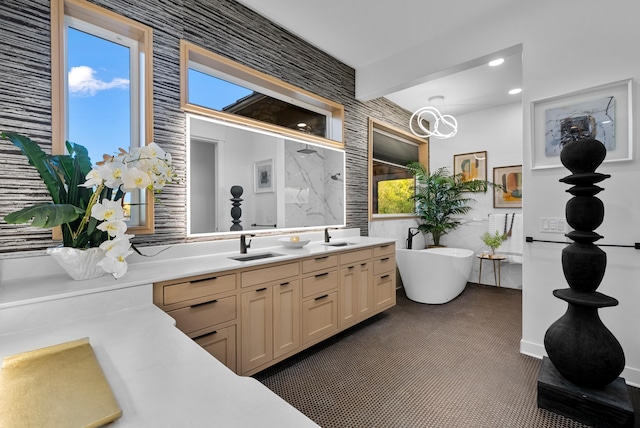 kitchen featuring light countertops, light brown cabinetry, beamed ceiling, and a sink