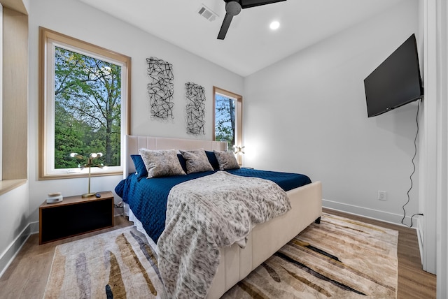 bedroom with recessed lighting, light wood-type flooring, visible vents, and baseboards