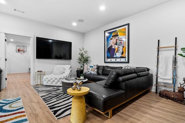 living area featuring recessed lighting, visible vents, and wood finished floors