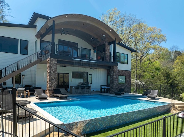 back of house with ceiling fan, a balcony, fence, stairs, and a patio area