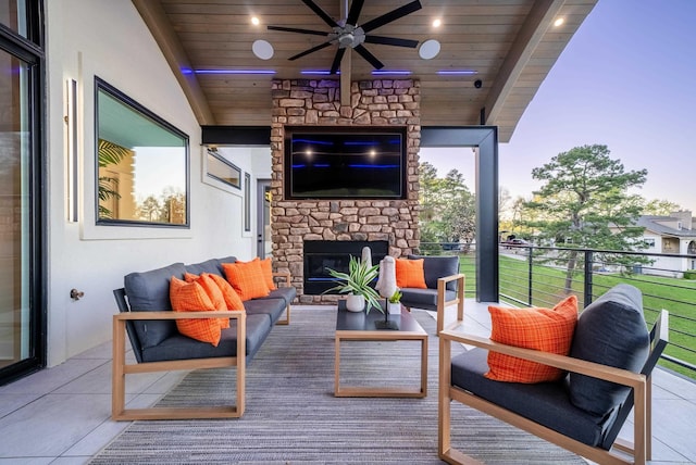 exterior space with an outdoor living space with a fireplace and ceiling fan