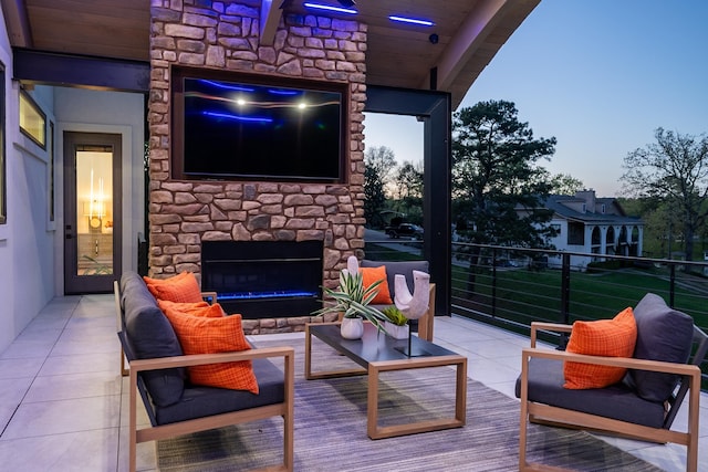 view of patio with an outdoor living space with a fireplace