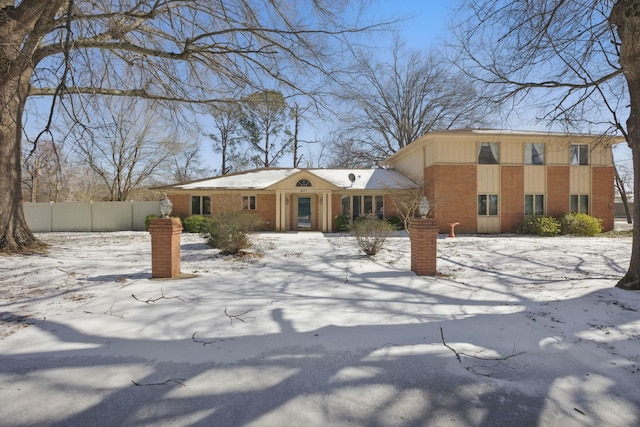 view of front of home with fence and brick siding