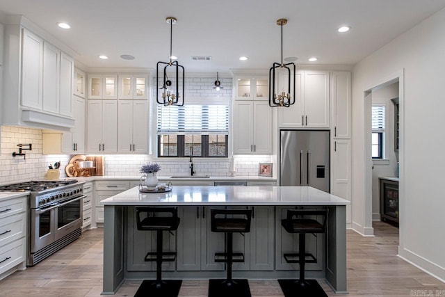 kitchen featuring a kitchen island, a kitchen breakfast bar, and high quality appliances