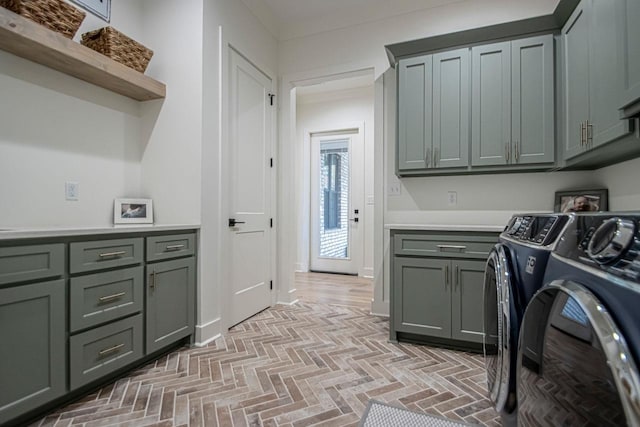 washroom with brick floor, washer and dryer, and cabinet space