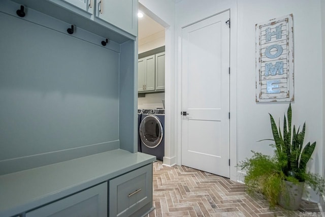 clothes washing area with cabinet space and washer and dryer