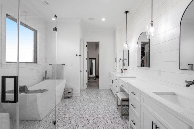 full bath with double vanity, a soaking tub, a spacious closet, a sink, and a shower stall