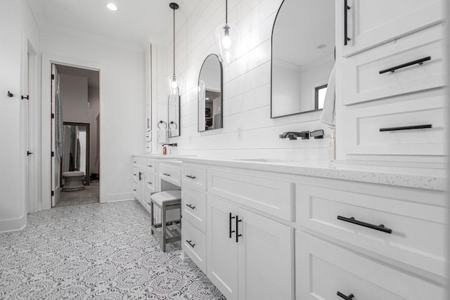 full bathroom featuring double vanity, baseboards, crown molding, a sink, and recessed lighting