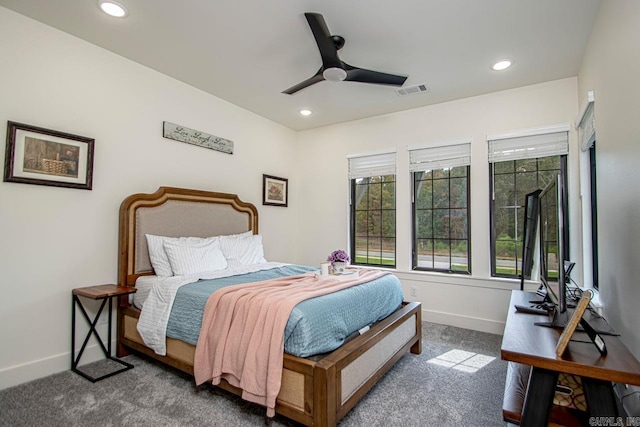 bedroom with baseboards, visible vents, and dark colored carpet