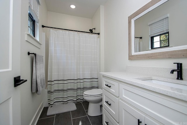 bathroom with toilet, tile patterned flooring, recessed lighting, and vanity