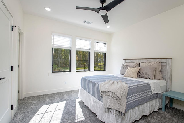 carpeted bedroom with a ceiling fan, recessed lighting, visible vents, and baseboards