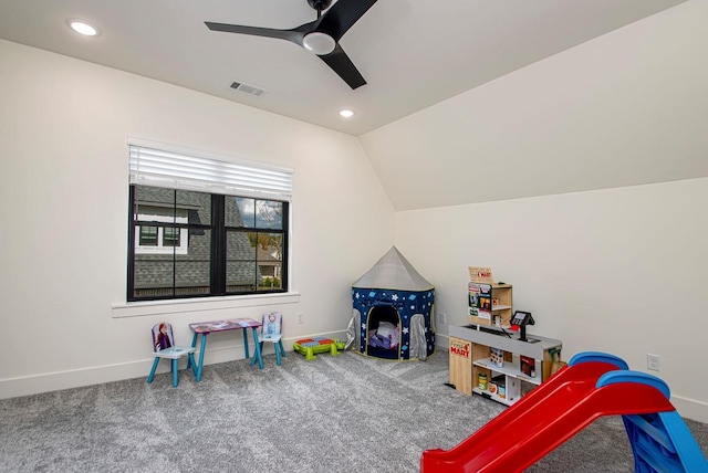 playroom featuring ceiling fan, carpet floors, visible vents, baseboards, and vaulted ceiling