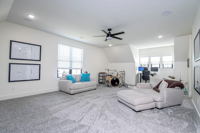 living room featuring lofted ceiling, baseboards, carpet floors, and ceiling fan