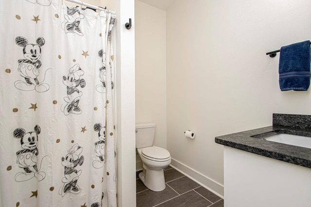 full bath with baseboards, toilet, vanity, and tile patterned floors