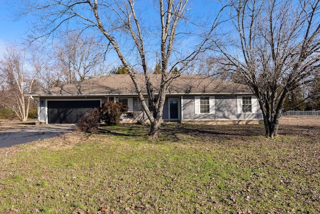 single story home featuring a front lawn, concrete driveway, and an attached garage