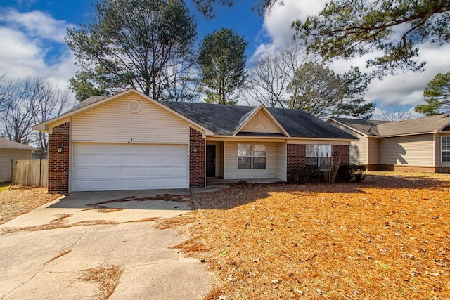 single story home with driveway, an attached garage, fence, and brick siding