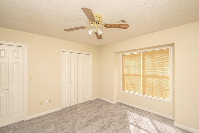 unfurnished bedroom with a textured ceiling and baseboards