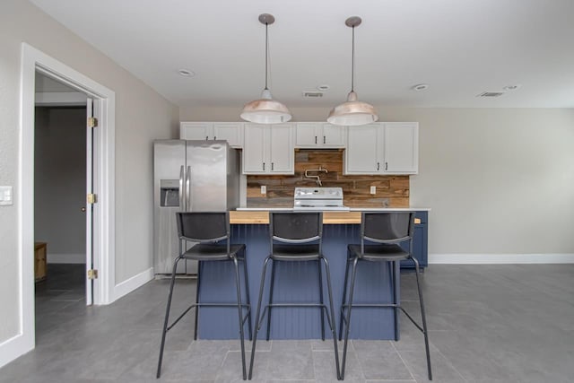 kitchen with light countertops, electric range, decorative backsplash, white cabinets, and a kitchen breakfast bar