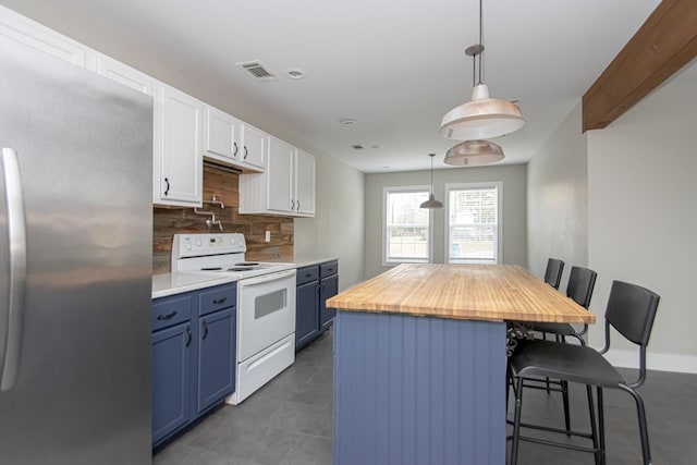 kitchen with blue cabinets, stainless steel fridge, a kitchen bar, and electric range