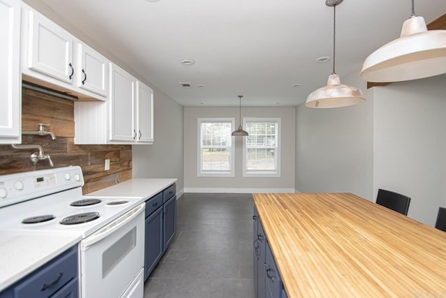 kitchen featuring light countertops, hanging light fixtures, and white electric range oven