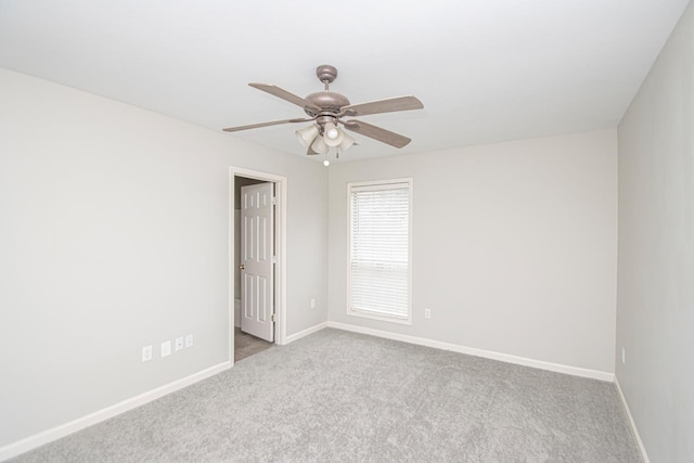 unfurnished room featuring light carpet, baseboards, and a ceiling fan