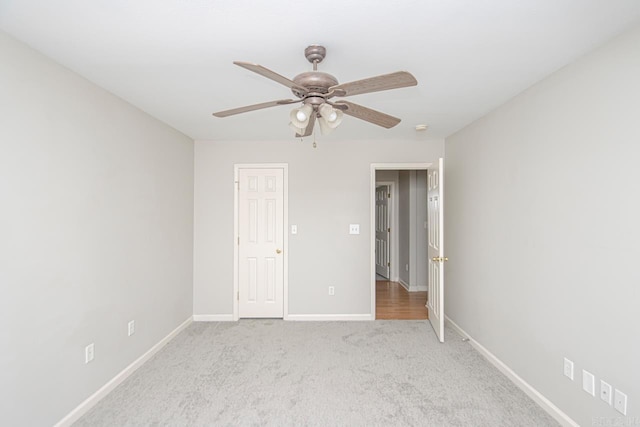 unfurnished bedroom with baseboards, a ceiling fan, and light colored carpet