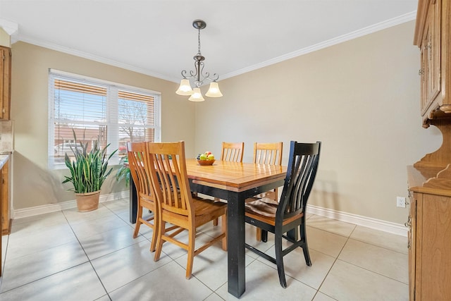 dining room with baseboards, ornamental molding, and a notable chandelier