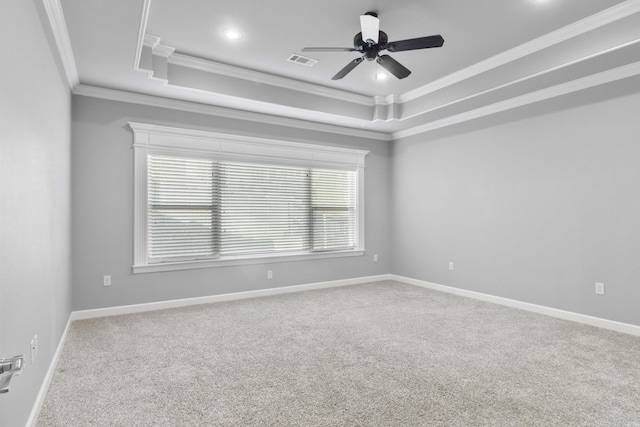 unfurnished room featuring baseboards, ceiling fan, carpet, a tray ceiling, and crown molding